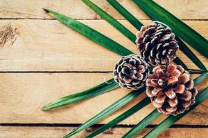 Pine cone on wood table background with space. photo