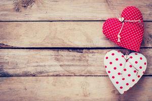 Two heart fabric on wooden table background. photo