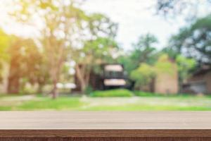Empty wooden table top and green bokeh display montage for product with space. photo