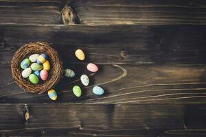 Eggs easter in the nest on wood background with copyspace. photo