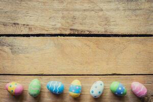 Colorful easter egg on wood background with space. photo