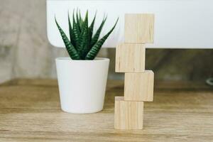 Four wooden toy cubes on wooden table background with copy space photo