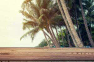 Blurred coconut on beach and wood table with space display for product. photo