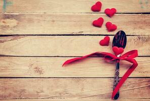 Table setting cutlery and red heart for dinner Valentine Day. photo