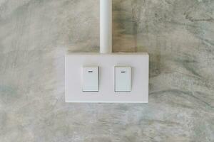 electrical light switch on cement wall background photo