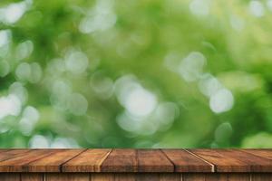 Empty wood table and green bokeh blur with copy space display montage for product. photo