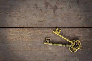 Old key vintage on wood background and texture with space.