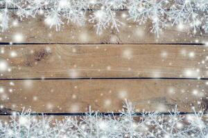 Wooden brown christmas background and snow white with snowflakes, copy space. photo