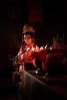 Chinese woman make wishes, pray, and light candles. On the occasion of the annual Chinese New Year festival, in a revered shrine or temple photo