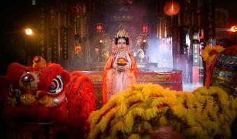 Chinese woman with yellow and red lions It is considered to enhance the prosperity for oneself on the occasion of the Chinese New Year festival every year photo