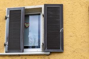 a window with dark brown shutters photo