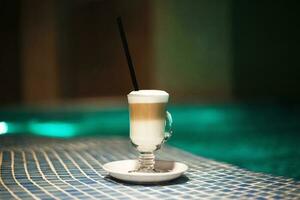 a cup of coffee on the side of the pool. rest in the spa center photo