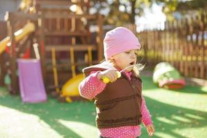 little girl blowing soap bubbles outdoor photo