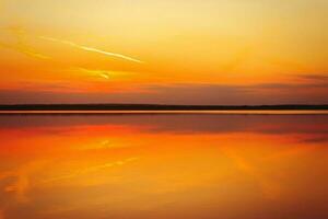 Reflection of a beautiful sunset over the water photo