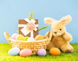 Bunny toy and Easter eggs in basket photo