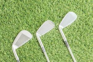 Row of golf club on grass photo