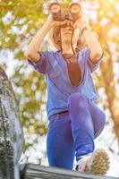 Close up Woman wear hat and hold binocular in grass field photo