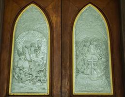 The Gothic style doors of Christian churches are solid and solid medieval art and can be seen in many European and Christian churches on solid wood doors and Jesus carvings on metal floors photo