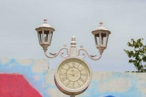 An antique but classic vintage clock lamp displayed in a landmark that serves as a tourist attraction for tourists to take photos as a souvenir of their journey.