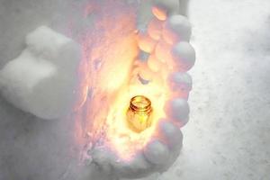 Top view of snow candles and small Sculpture in heart shape on snow floor background. Snow candles are activities of The Otaru Snow Light Path Festival at Otaru, Hokkaido prefecture, Japan. photo