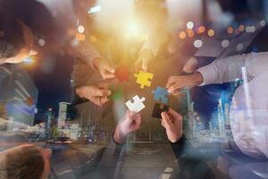 Teamwork of partners. Concept of integration and startup with puzzle pieces photo