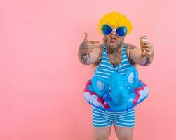 Fat man with beard and wig eats an icecream photo