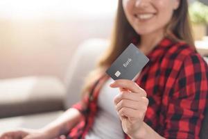 Girl is ready to pay with credit card on an online store photo