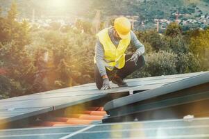 Workers assemble energy system with solar panel for electricity photo