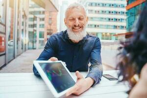 Businessman shows trading stock market chart on a tablet photo