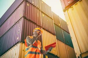 Worker communicate using radio to control loading containers at port cargo photo