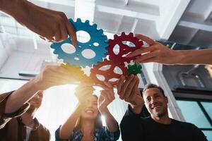 Business team connect pieces of gears. Teamwork, partnership and integration concept photo