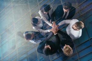 Business people putting their hands together. Concept of integration, teamwork and partnership. double exposure photo