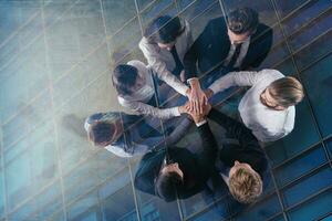 Business people putting their hands together. Concept of integration, teamwork and partnership. double exposure photo