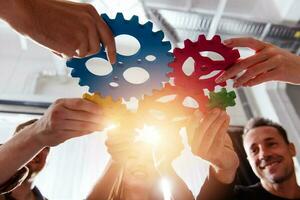 Business team connect pieces of gears. Teamwork, partnership and integration concept photo