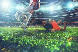 Close up of a football action scene with competing soccer players at the stadium during a night match photo