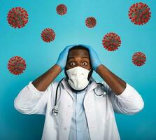 Worried medic is worried and afraid of the covid 19 corona virus. Blue background photo