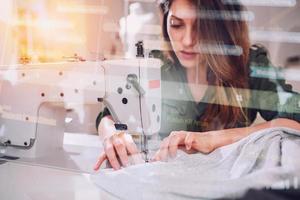 Seamstress works to new clothes ordered by internet client photo