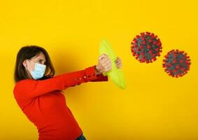 Woman protects herself from covid-19 virus attack with a shield photo