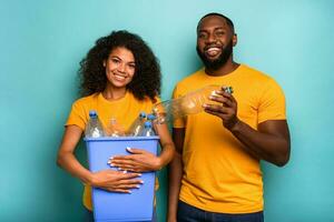 Couple hold a plastic container with bottles as concept of ecology and recycling photo