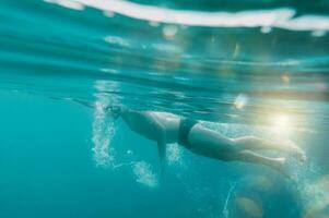 Sporty man swims fast in the sea photo