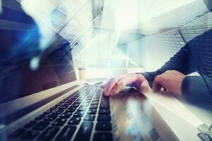 Business man works in office with laptop in the foreground. Concept of teamwork and partnership. double exposure with network effects photo