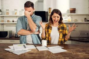 Couple have a problem with bills. Concept of economic trouble and failure photo