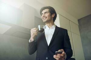 Businessman works with his smartphone at home photo