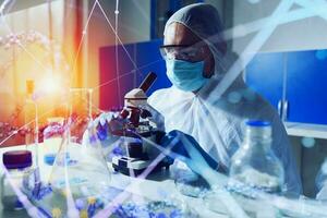 Doctor in the laboratory analyzes samples under a microscope. Pharmaceutical treatment concept. photo