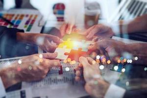 Teamwork of partners. Concept of integration and startup with puzzle pieces photo