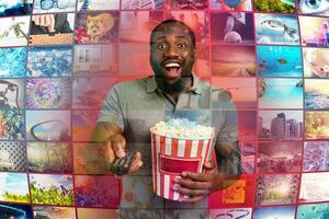 Man has fun watching a film. Concept of entertainment and streaming tv. red background photo