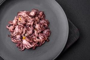 Delicious marinated octopus babies with lemon, salt and spices photo