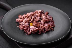 Delicious marinated octopus babies with lemon, salt and spices photo