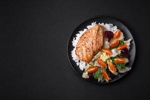 Delicious healthy breakfast consisting of chicken, rice, greens and cherry tomatoes photo