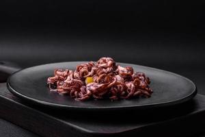 Delicious marinated octopus babies with lemon, salt and spices photo